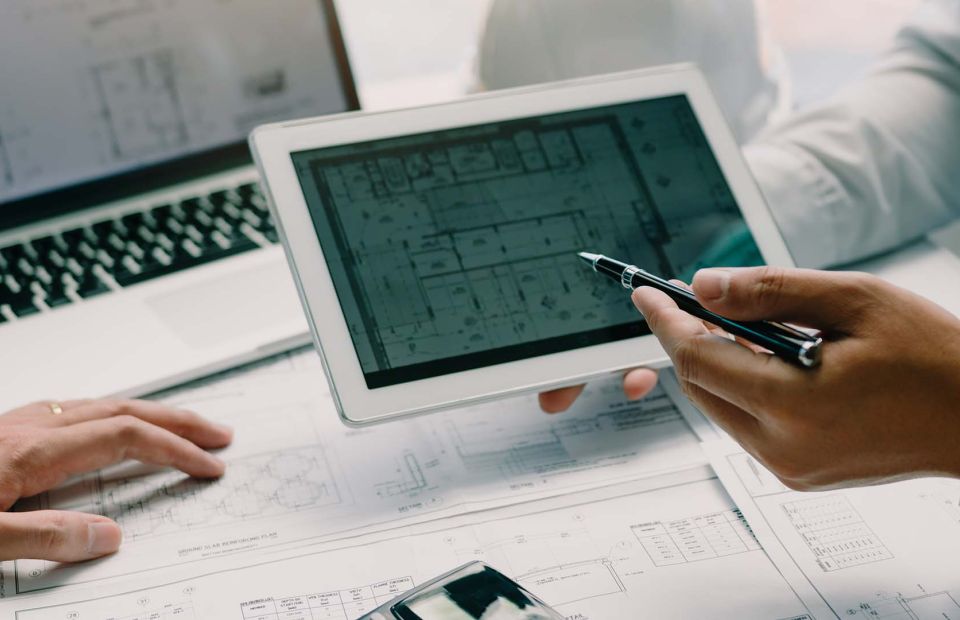 An individual working on architectural drawings